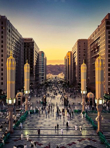 Pedestrian plaza leading toward the mountains at sunset
